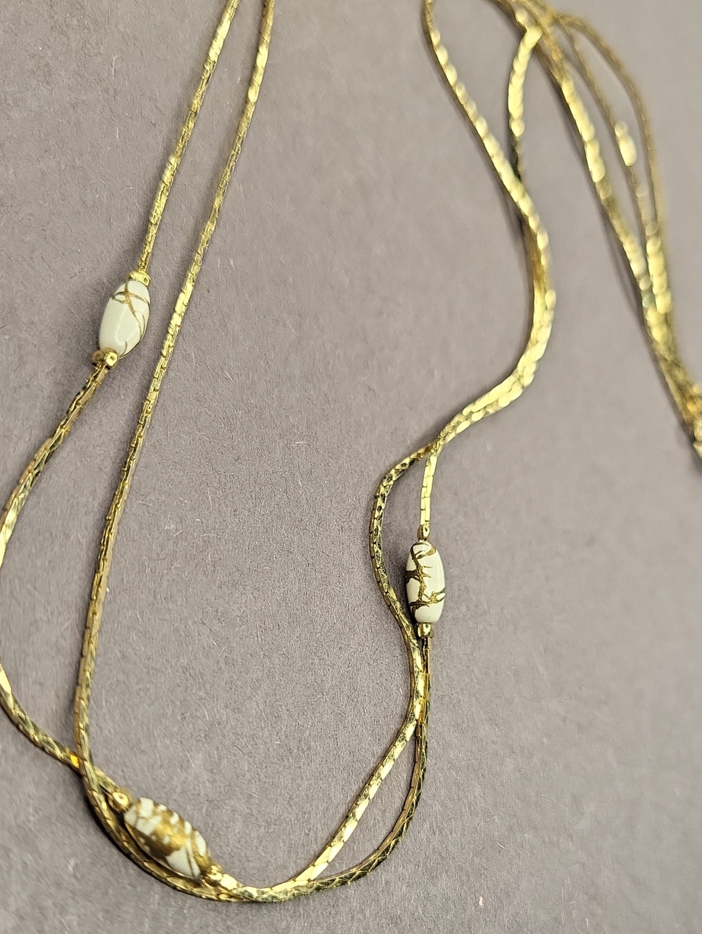 Delicate Gold Multi-Strand Necklace with Cream Marbled Beads
